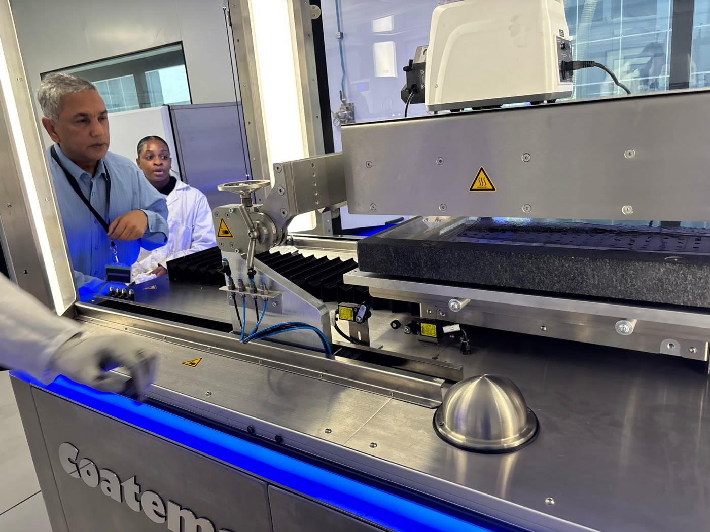 Isondo staff working with the precision coating equipment at the OR Tambo SEZ facility.