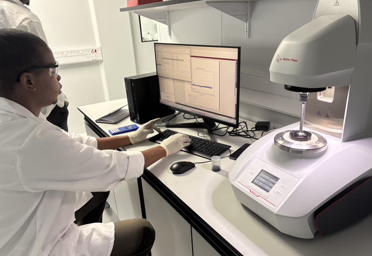 An Isondo analyst operating a precision rheometer in the analytical laboratory.