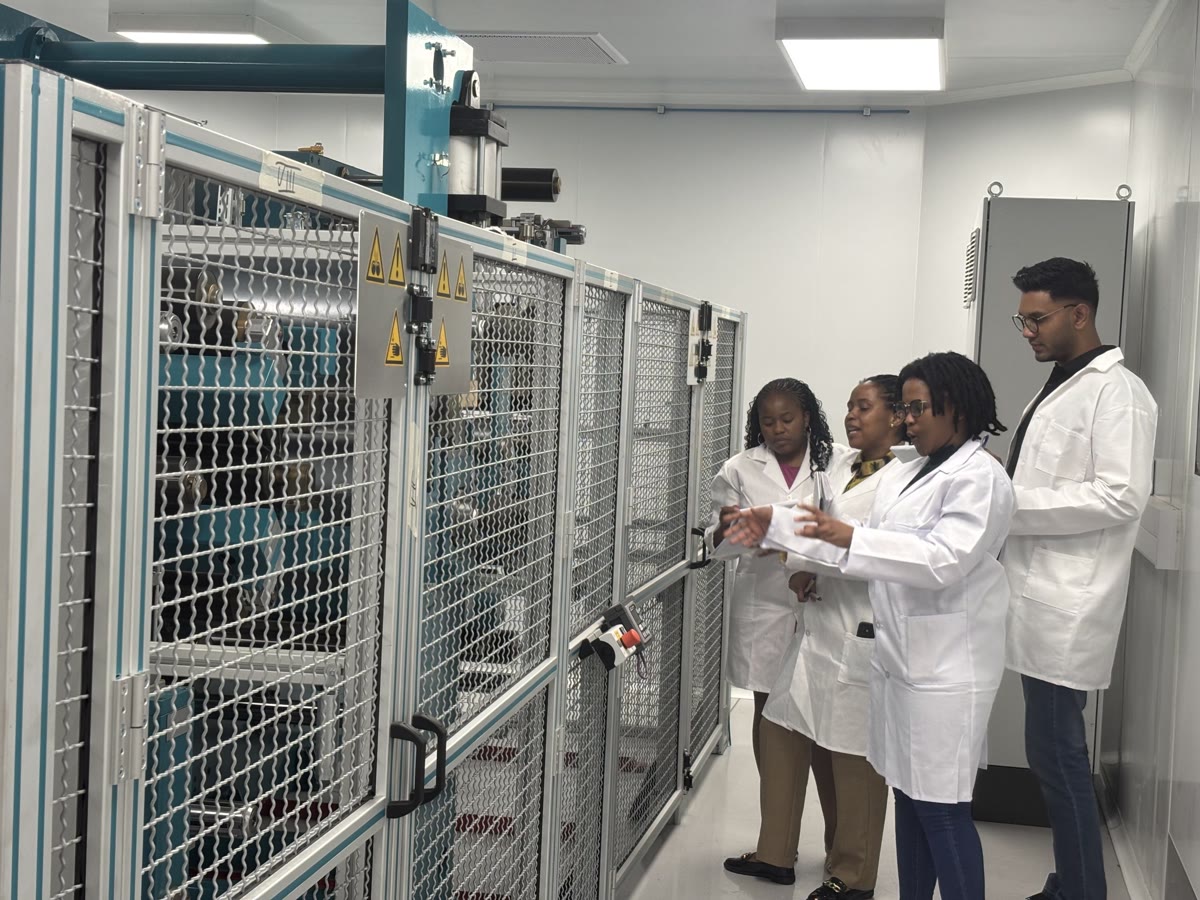 Isondo technical staff working alongside the production line.